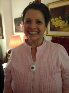 picture of author's mom smiling wearing a small pendent around her neck - the mobile medical alert device