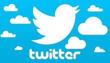 image of twitter logo with a bird and clouds in a light blue background
