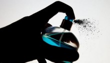 A perfume bottle spritzing