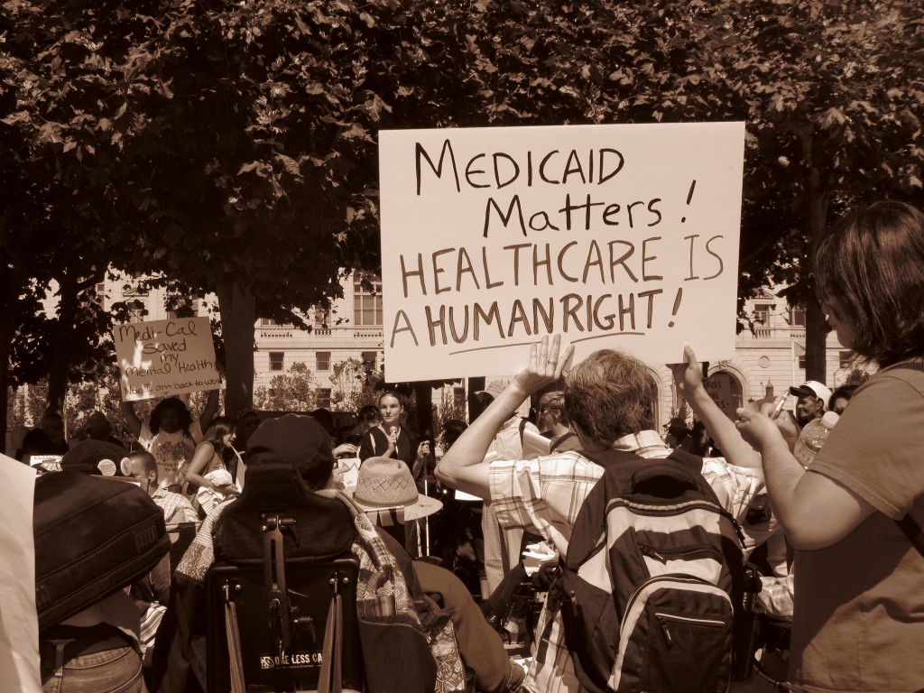 group of people with disabilities holding signs that state "Medicaid Matters! Health care is a human right" 