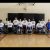 The Sacramento Royals Wheelchair Basketball team posing for a group photo in their white uniforms.