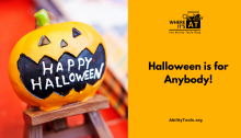 A toy jack-o-lantern with the phrase "Happy Halloween" printed in it's open mouth. Under the Where it's AT logo, the text reads "Halloween is for anybody!" - abilitytools.org