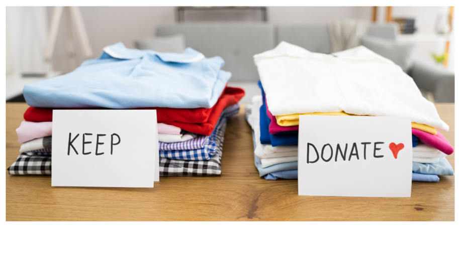 Two piles of folded shirts on wooden table. First pile is labeled KEEP and second pile is labeled DONATE