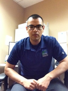 picture of Jorge Ruiz from CCCL wearing a blue polo with CCCIL's logo on it sitting in a chair