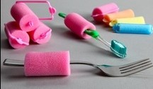 pink hari rollers used as grips for toothbrush and fork