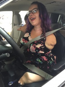 picture of a young woman with purple hair and glasses without limbs in her new van