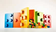 Photo of colorful Braille Bricks boxes with the Braille Brick lego's falling out.