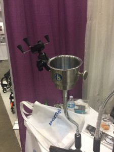 A mounting system for a wheelchair user that has a cup and cell phone holder attached