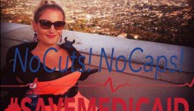 Kim in her powerchair with the LA skyline behind her and a filter over the phote that reads "no cuts, no caps, #savemedicaid