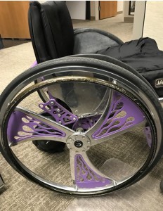 side view of Farah's wheelchair showing off the purple flame rims 