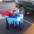 Little boy dressed as super man along with a fake torso off the back of his wheelchair that gives the illusion he is flying over the city scape