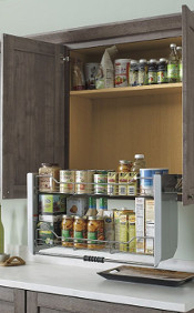 There is a pull down shelf in the pantry with spices and oils on it. 