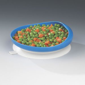 A photo of a plate suctioned to a table. It has a large blue rim holding peas and carrots.