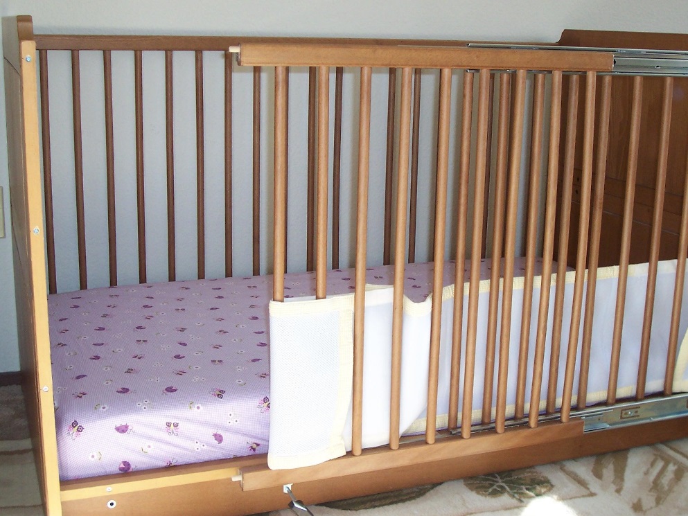 Picture of wooden crib with modified sliding door