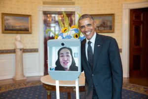 President Barack Obama greets Alice Wong, Disability Visibility Project Founder, via robot, during the Americans with Disabilities Act 25th Anniversary reception in the Blue Room of the White House, July 20, 2015