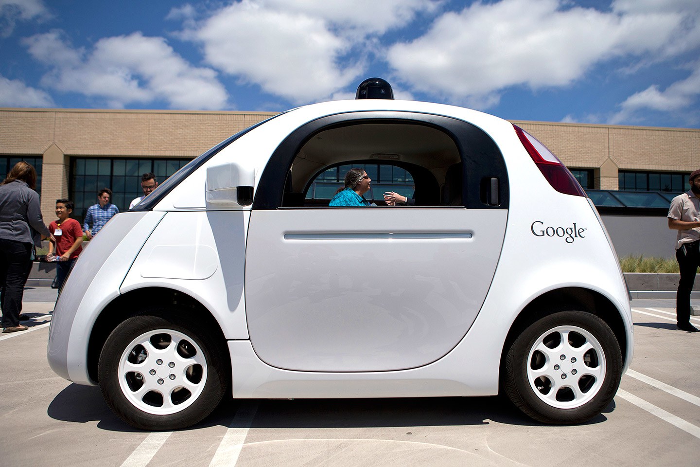 A picture of a white Google self-driving car. CFILC''s former Executive Director, Teresa, can be seen through the window of the car. 