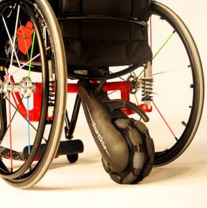 wheelchair with a power assist motorized wheel attached to the back with 'smartdrive' printed on it 