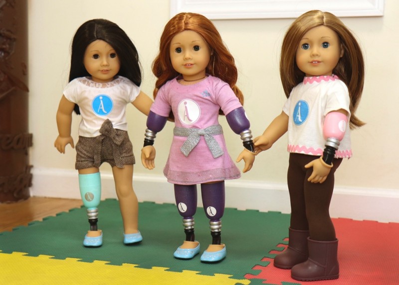 Three American Girl dolls, modified to have prosthetics.