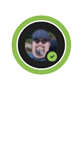 A Teams profile bubble with a green ring around it with the "Available"  icon in the bottom right corner.  The profile picture contains a close up of a man with a goatee, cap and sunglasses.